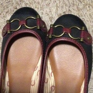 Shoes never worn. They are black with a reddish leather trim